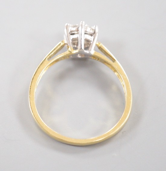 A modern 18ct gold and seven stone diamond set circular cluster ring, size P, gross weight 3.7 grams
